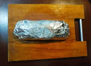 Wrap the roll in foil in several layers. Send to an oven heated to 200 degrees for 1 hour.