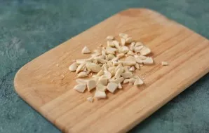 Toast the nuts in a dry frying pan and chop coarsely with a knife.