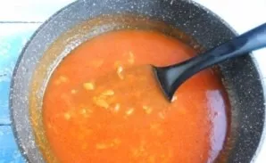 Add tomato paste and hot water, mix. Add sugar, salt and pepper. Simmer for 5 minutes, then add the minced garlic.