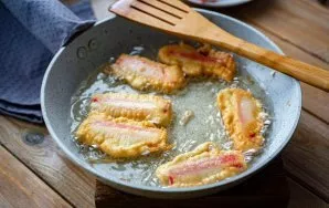 In a pan over medium heat, heat a large amount of vegetable oil. Carefully place the crab sticks in the bubbling oil and fry on all sides...
