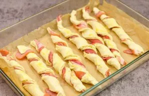 Transfer the prepared sticks to a baking sheet lined with baking paper. Brush all sticks with an egg. Then bake at a temperature of 180 d...