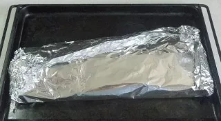 Wrap the fish in foil, place it on a baking sheet.