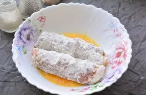 Dip the rolls in the beaten egg.