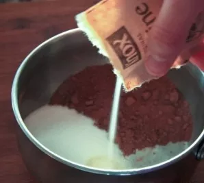 Take a small pot and mix cocoa powder, remaining sugar and a bag of gelatin in it.