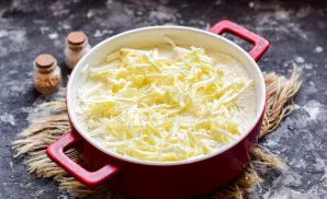 Grate the butter on a medium grater, put it on top of the workpiece. Bake the cake in the oven for 30 minutes at a temperature of 180 deg...