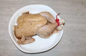 Cover the baking dish with baking paper, place the chicken. Place in an oven heated to 180 degrees.