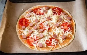 Evenly distribute the grated suluguni cheese on top.