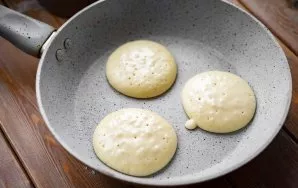 Heat a dry frying pan over medium heat and pour the dough in a spoonful to form pancakes. Fry on one side until bubbles appear on the sur...