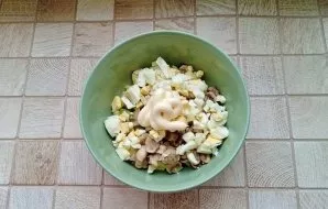 Season the salad with mayonnaise.