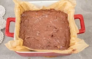 Line a baking sheet with a diameter of 25*25 cm with baking paper. Pour in the dough and bake in an oven preheated to 170 degrees for 40-...