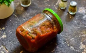 Lay out the beans in sterile jars, immediately roll up and turn them upside down, roll them up and leave for a day.