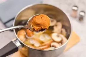 Then add tom yum paste to the soup and bring to a boil.