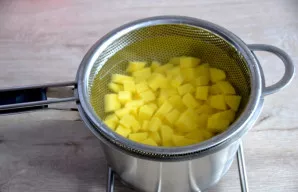 Cut the potatoes into cubes and cook in salted water until almost soft.