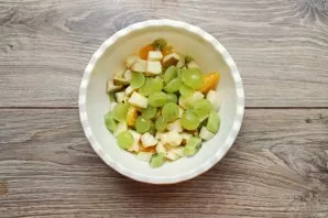 Separate the grapes from the twig, cut in half and remove the seeds. Add the berries to the fruit. Transfer the salad to a serving bowl a...