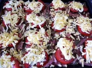 Place tomato slices on the mushrooms, spread them with mayonnaise and sprinkle with cheese grated on a coarse grater. Place the baking tr...
