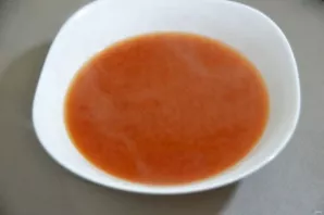 While the meat is cooking, prepare the broth or boiling water in which to dilute the tomato paste.