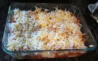 On a fine grater, grate hard cheese and sprinkle on top. Place in a well-preheated oven. The pasta baked in the oven will be ready in 40-...