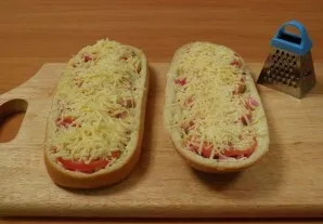 Sprinkle grated cheese on top and place the pizza in the oven. Bake until the cheese is completely melted.