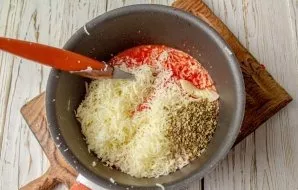 Pour the resulting sauce into a saucepan with a thick bottom, grate the cheese, add oregano. Put on the stove and simmer over low heat un...