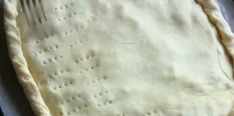 Arrange the filling, place the other part of the dough, press the edges. Make lines with a fork. Brush the beaten cake with egg. Bake for...