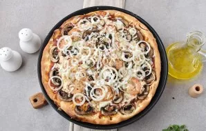 Bake the pizza in a well-heated oven for 15-20 minutes. The dough should brown around the edges, the cheese should melt and bubble.