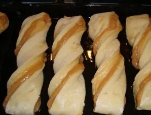 Cut the dough into strips about 4 cm wide. Turn the strips a little, put them on a greased baking sheet and leave to stay for about 20 mi...