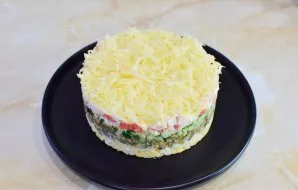Put grated cheese on top layer and remove the serving ring.