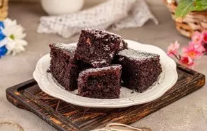 Remove the cake, let cool slightly, then cut into squares. Enjoy your meal!