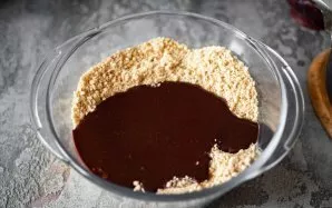 Put all the cookie crumbs from the chopper bowl in a large bowl and pour the chocolate mixture over them.