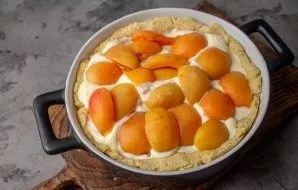 On top of the filling, slightly immerse the apricot halves. Put the cake in the oven again and bake at a temperature of 180 degrees for a...