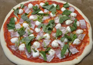 Roll the dough into a circle with a diameter of 30 cm, spread it with tomato sauce, add slices of bacon, mozzarella, basil, sprinkle with...