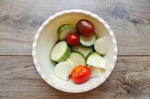 Cut the zucchini into rings or slices, peel the onion and cut lengthwise into pieces. Put all the vegetables in a bowl, pour in vegetable...