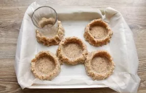 Using a dry glass, make indentations and press the edges to the glass, making like nests.