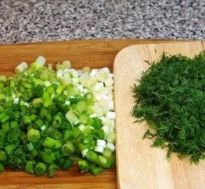Add chopped herbs (onions and dill) to the mixture to taste.