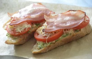 Baked sandwich with bacon, tomatoes and cheese.