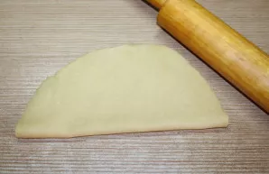 Fold the dough in half. Roll out a little.