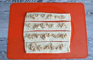 Roll out the dough into a layer 0.3 cm thick. Cut into strips 5 cm wide and 20-22 cm long. In the center of the strip put 1 teaspoon of f...