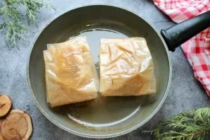 Grease the pan with a little vegetable oil, heat it and put the envelopes with cutlets. Fry them on both sides over medium heat until gol...