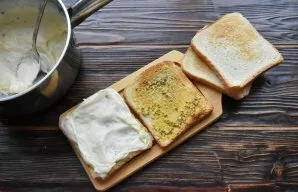 Apply 2 tablespoons of Mornay sauce to the mustard and distribute with it the entire surface of the toast, including the edges.