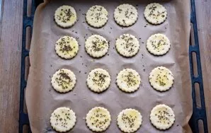 Line the baking sheet with baking paper and lay out all the future cookie blanks. Brush each piece with a silicone brush with whipped egg...