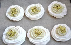 Fill the holes in the meringues with pistachio cream. It is better to do this through a pastry bag with a curly tip. Spread the crushed p...