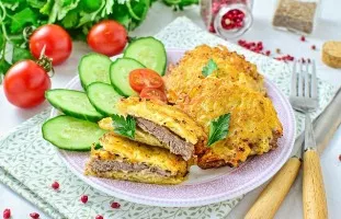 Pieces of pork in potato dough in a pan