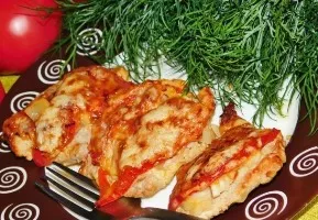 Pork steaks with vegetables and cheese in the oven