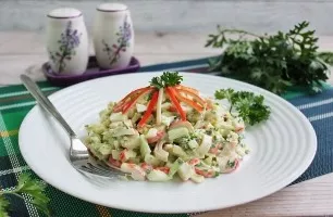 Crab stick salad with onions and herbs