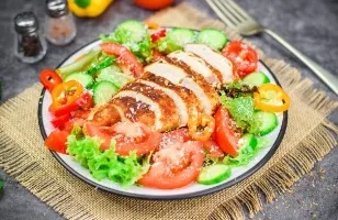 Salad with fried chicken breast and vegetables