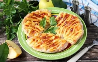 Chicken breast with apples and cheese in the oven